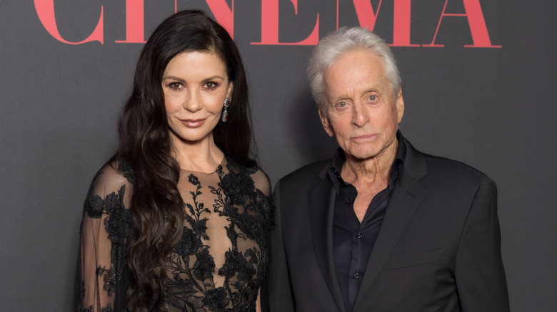 Catherine Zeta-Jones posing for photos with Michael Douglas in all-black outfits