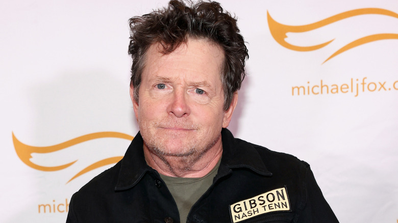 Michael J. Fox posing on the red carpet at an event for his charity