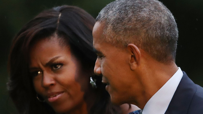 Former President Barack Obama and Michelle Obama walking 