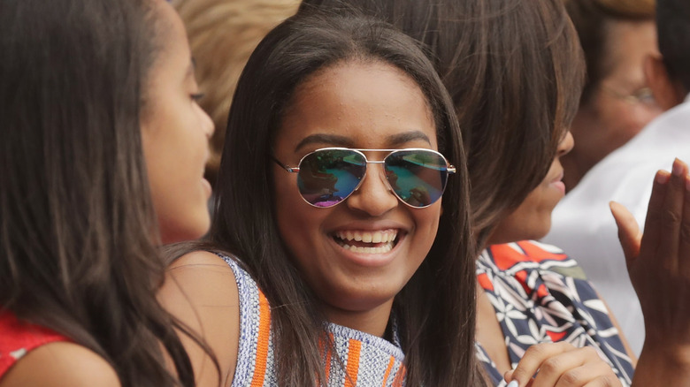 Malia Obama smiling in sunglasses