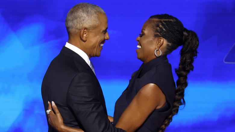 Barack and Michelle Obama hugging at the 2024 DNC