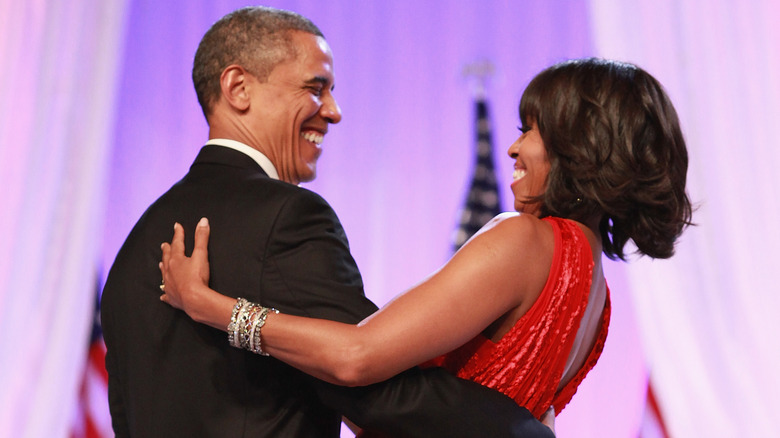Michelle and Barack Obama dancing together.