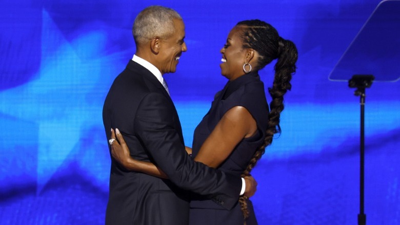 Barack Obama embraces Michelle Obama onstage during the DNC in Chicago, IL (2024)