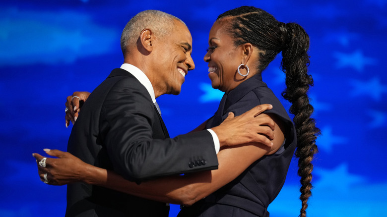 Barack and Michelle Obama embracing at DNC 2024