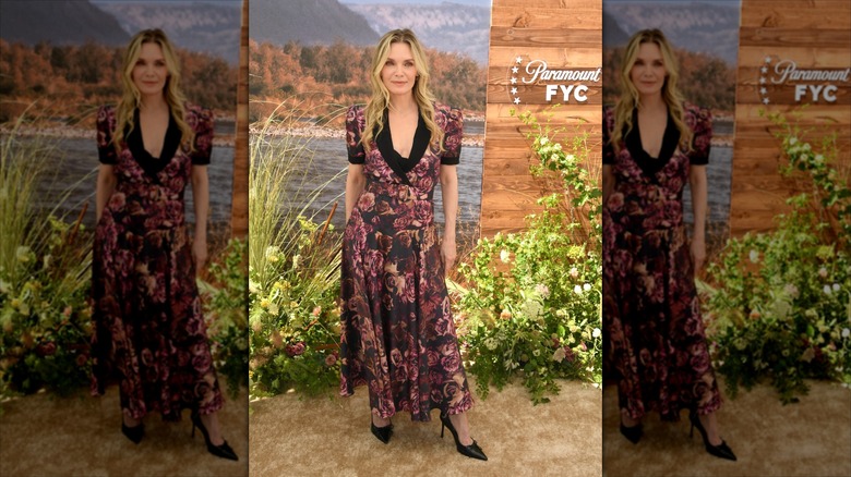 Michelle Pfeiffer in a floral dress with a black cow-neckline and pointy black heels