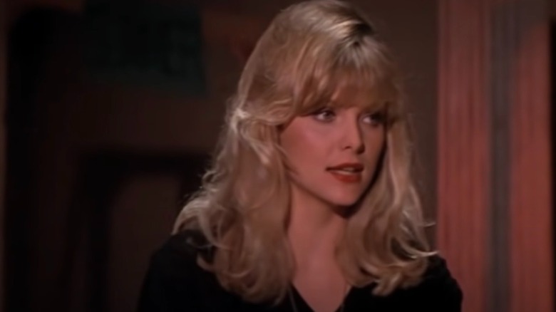 Michelle Pfeiffer with bangs and red lipstick in black jjacket on set of "Grease 2"