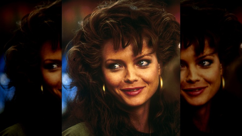 Michelle Pfeiffer with dark hair and gold hoop earrings