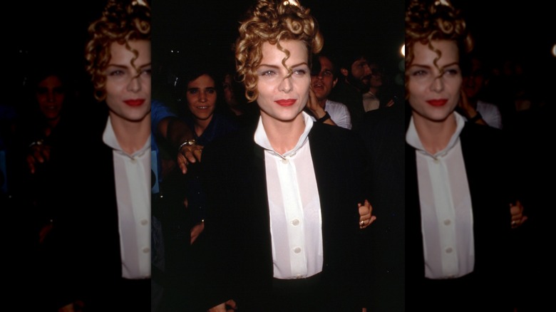 Michelle Pfeiffer in white shirt and black blazer with strawberry blonde curls piled on her head