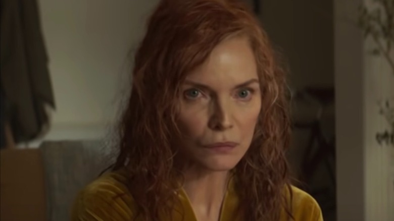 Michelle Pfeiffer unsmiling with red hair in French Exit