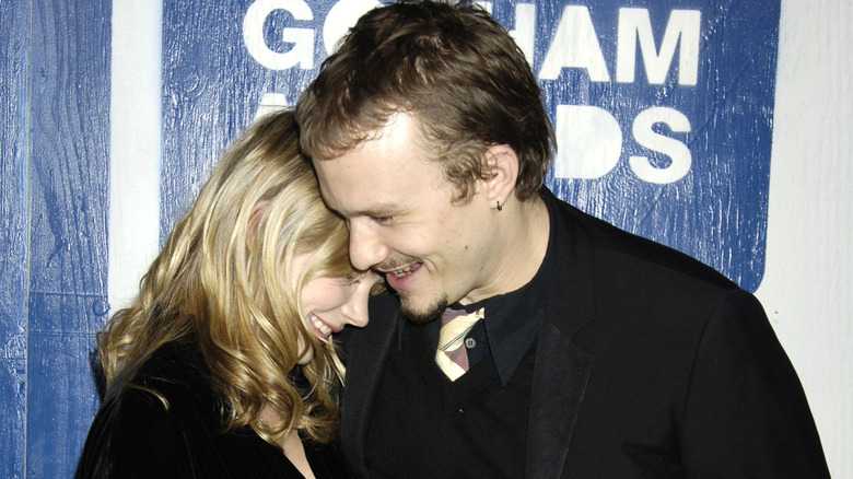 Michelle Williams and Heath Ledger hugging and laughing