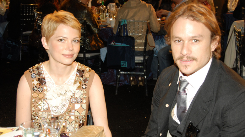 Michelle Williams and Heath Ledger sitting together at an awards show