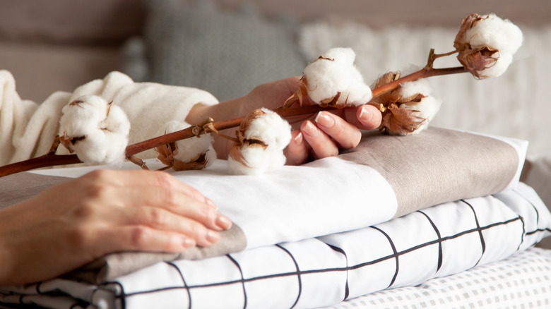 Woman holding cotton over sheets