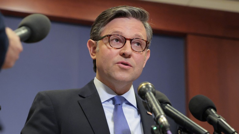 Mike Johnson speaking into multiple microphones