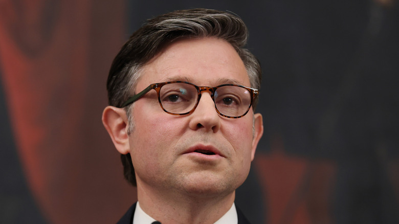 Mike Johnson wearing glasses with his mouth open