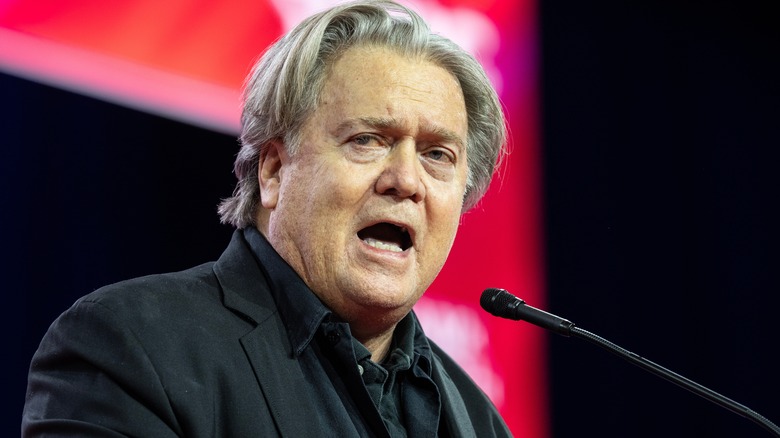 Steve Bannon making a speech in a black suit