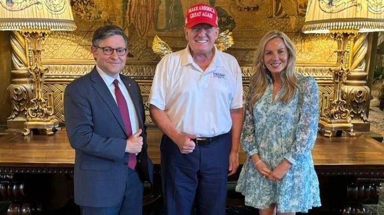 Mike Johnson, Donald Trump, and Kelly Johnson pose together in Mar-A-Lago (2024)