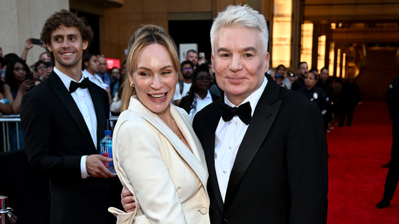 Kelly Tisdale smiling while Mike Myers grins
