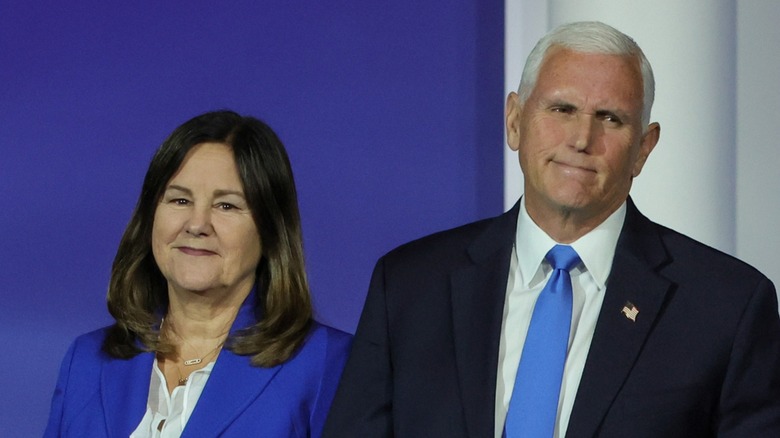 Karen and Mike Pence in front of a blue and white wall
