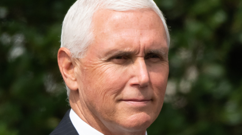 Mike Pence against a green background