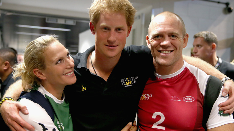 Prince Harry and Mike and Zara Tindall smiling and posing.