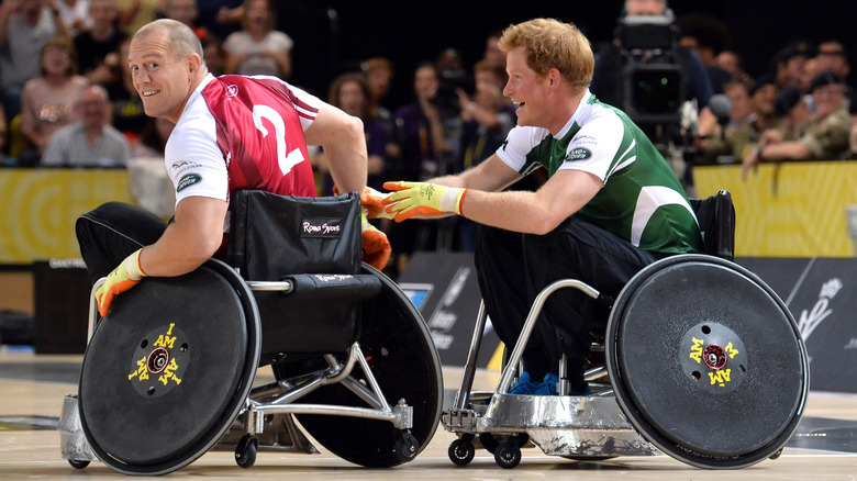 Mike Tindall and Prince Harry competing in a wheel chair sport.