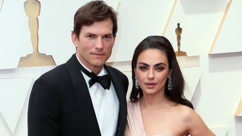Ashton Kutcher posing with Mila Kunis at the Oscars