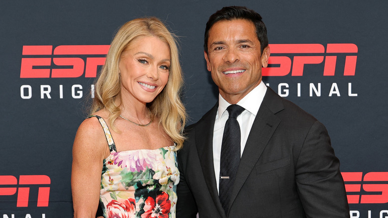 Kelly Ripa and Mark Consuelos smiling while posing together at an ESPN event
