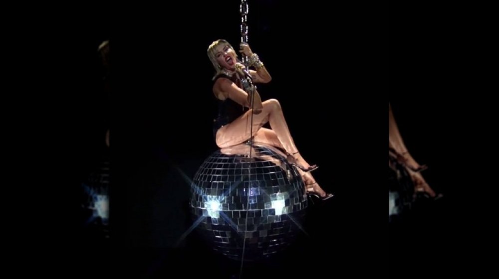Miley Cyrus swings on giant disco ball in 2020 MTV VMA performance
