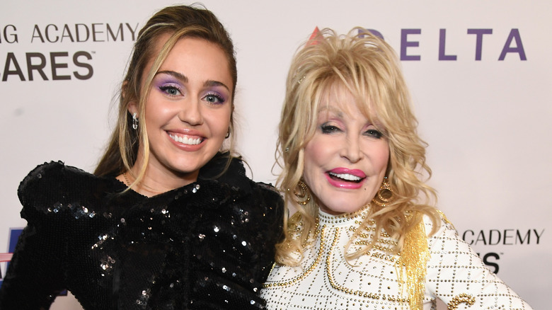 Miley Cyrus (L) and Dolly Parton attend MusiCares Person of the Year honoring Dolly Parton at Los Angeles Convention Center on February 8, 2019 in Los Angeles, California.