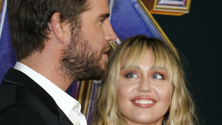 Miley Cyrus looking up at Liam Hemsworth