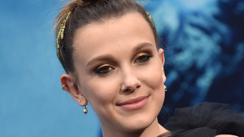 Millie Bobby Brown looking to the side with slight smirk