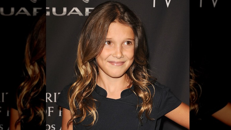 Closeup of young Millie Bobby Brown attending red carpet event wearing black