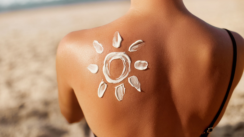 woman with sun design on her back