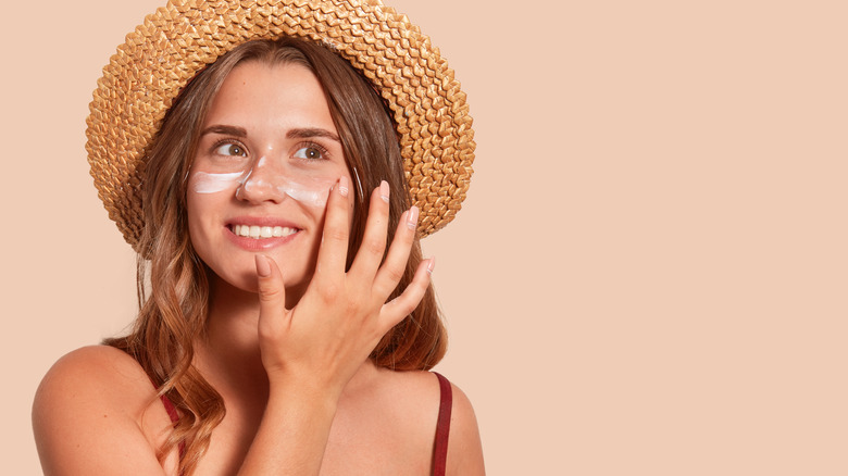 Woman applying sunscreen