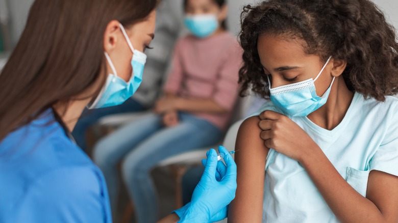 Young girl receiving vaccination