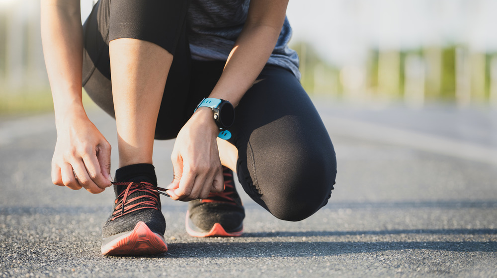 Person lacing up running shoes 