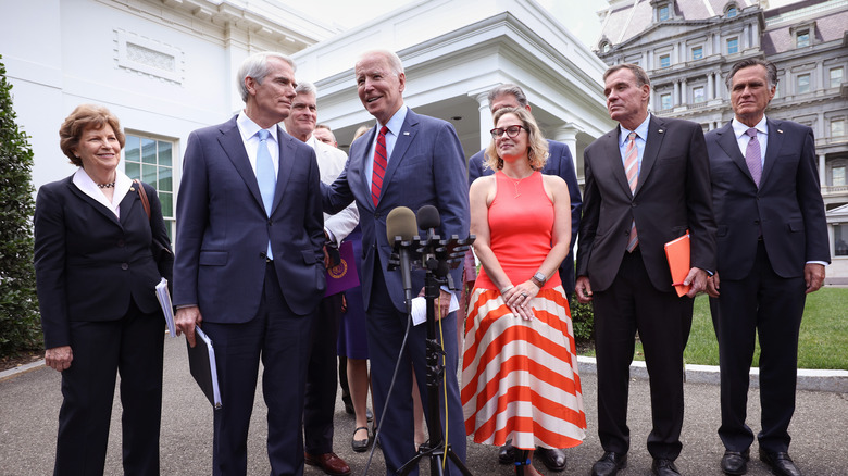 Joe Biden with bipartisan group of senators including Rob Portman and Krysten Sinema