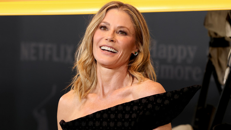 Julie Bowen smiling while wearing an off the shoulder black dress