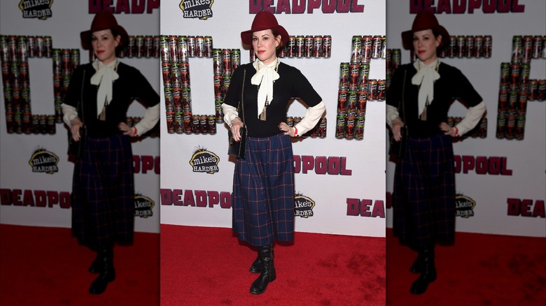 Molly Ringwald poses with her hand on her hip