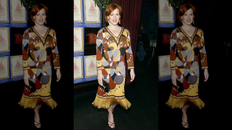 Molly Ringwald smiles in a multi-colored dress