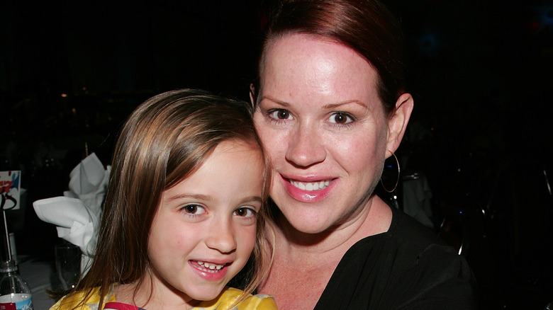 Young Mathilda Gianopoulos smiling with Molly Ringwald