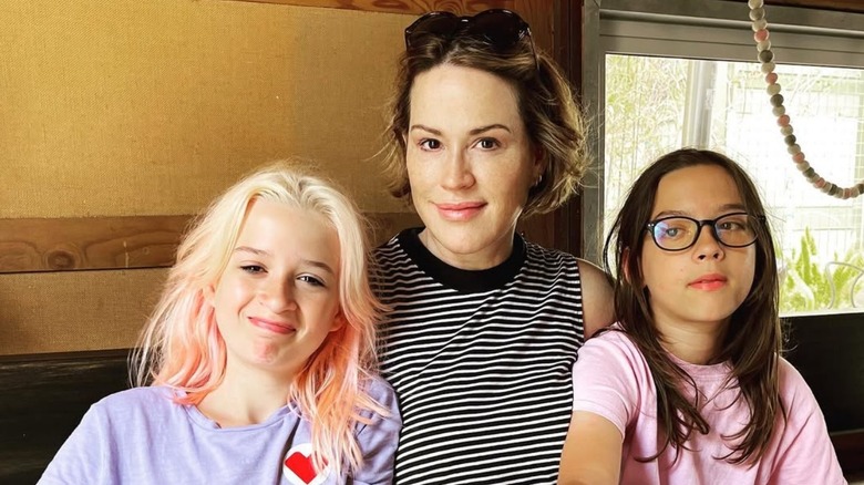 Molly Ringwald posing with Adele and Roman Gianopoulos