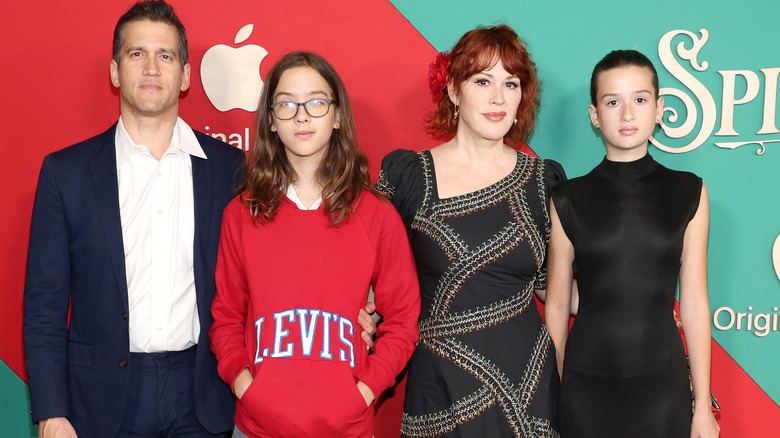 Molly Ringwald, Panio, Roman, and Adele Gianopoulos posing at the premiere of "Spirited" in 2022