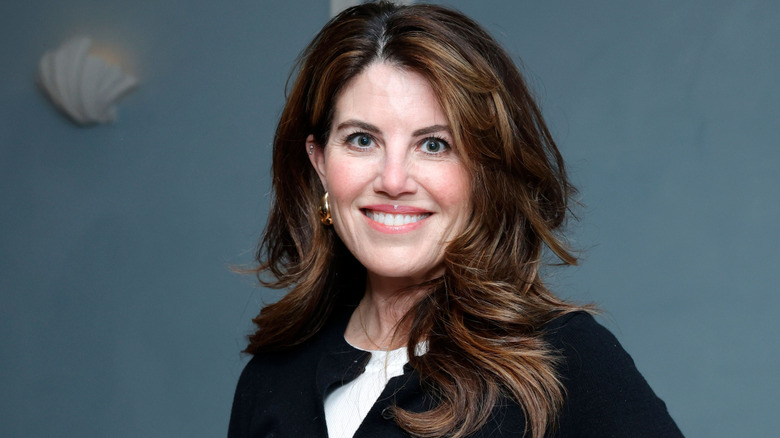 Monica Lewinsky smiling with curly hair.