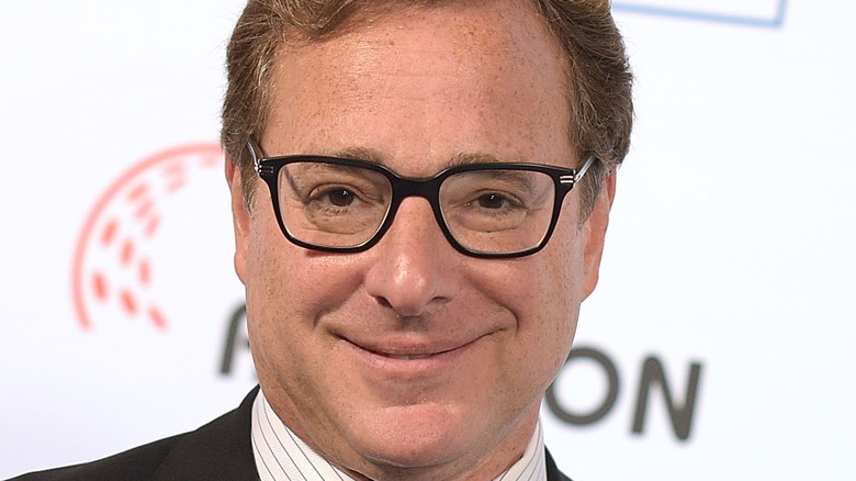 Bob Saget smiling on the red carpet