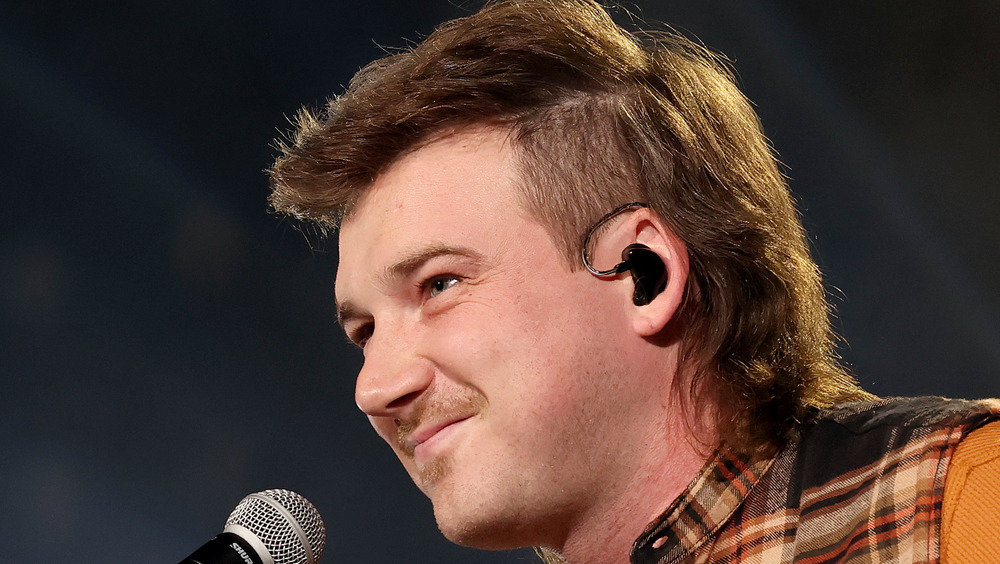 Morgan Wallen singing at a microphone