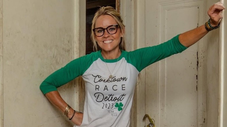 Nicole Curtis wearing glasses and smiling at a renovation
