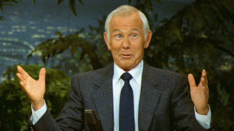 Johnny Carson behind his desk on the set of The Tonight Show