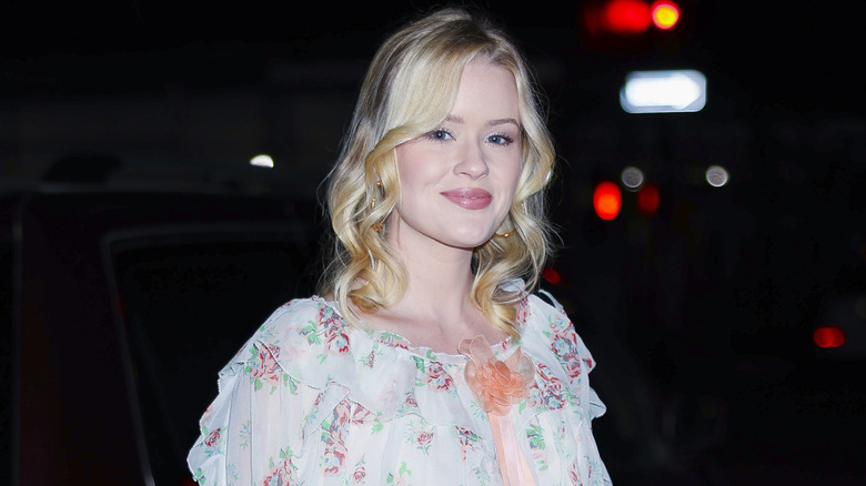 Ava Phillippe smiling outside at night in New York City.