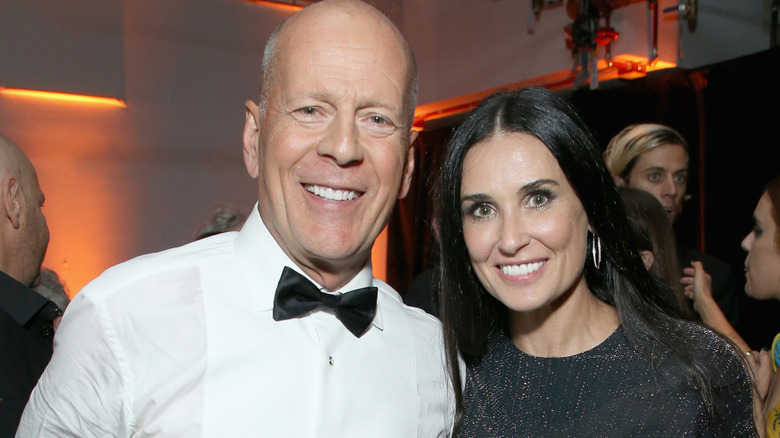 Bruce Willis and Demi Moore smiling for a photo
